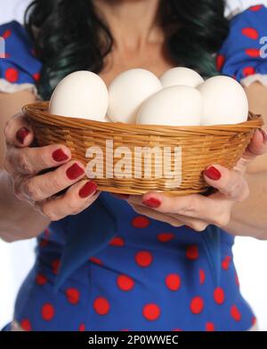 Woman in Retro Dress Holding Basket of Fresh Eggs Closeup Stock Photo