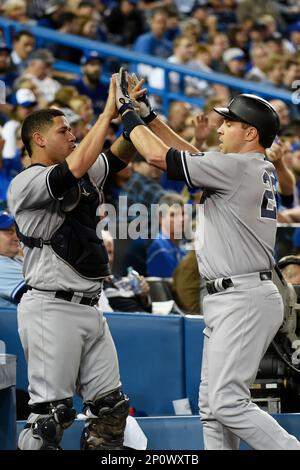 Houston Astros Yuli Gurriel (L) scores against New York Yankees catcher  Gary Sanchez in the fifth inning on a double by teammate Brian McCan in  game 7 of the American League Championship