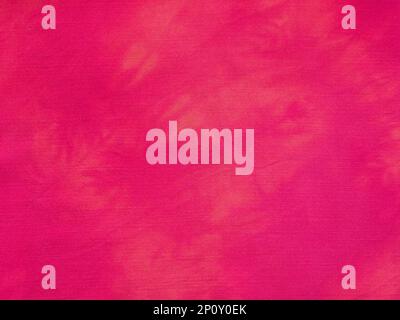 textile background - fabric dyed at home in red with tie-dye stains Stock Photo