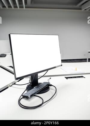 computer monitor with cutout screen on white table in empty office Stock Photo