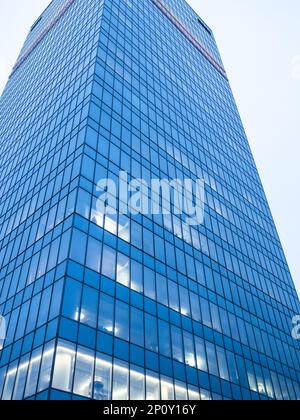 bottom view of glass tower of skyscraper in blue evening twilight Stock Photo