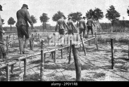 'L'instruction de la Nouvelle armee Belge; L'entrainement de la Nouvelle armee Belge. Dans un centre d'instruction du genie : en haut, harponnage et arrachage des piquets soutenant les fils barbeles, pour pratiquer une trouee a travers le reseau : a gauche, hommes creusant un passage souterrain pour eviter l'obstacle des chevaux de frise : a droite, passage au-dessus des reseaux au moyen d'une legere passerelle rapidement construite.', 1916. From &quot;Collection de la Guerre IV. L'Illustration Tome CXLVII. La Guerre Juillet, Aout, Septembre, Octobre, Novembre, Decembre 1916&quot;. Stock Photo