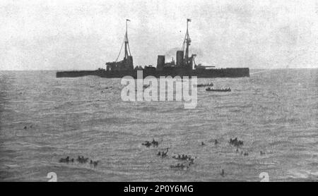 ''La Victoire Britannique des Iles Falkland; L' &quot;Inflexible&quot;, sous vapeur a l'arriere-plan, et &quot;Invincible&quot;, d'ou cette photographie a ete prise, recueillent les survivants', 1914. From &quot;L'Album de la Guerre 1914-1919: Volume I&quot;. [L'Illustration, Paris, 1926]. Stock Photo