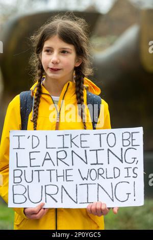 London, UK.  3 March 2023.  A young activist taking a day off school and participating in ‘Fridays For Future’ in Westminster to protest against the lack of government action on the climate crisis.  Other climate strikes are taking place around the world based in a movement which began in August 2018, after 15-year-old Greta Thunberg and other young activists protested in front of the Swedish parliament every school day for three weeks  Credit: Stephen Chung / Alamy Live News Stock Photo