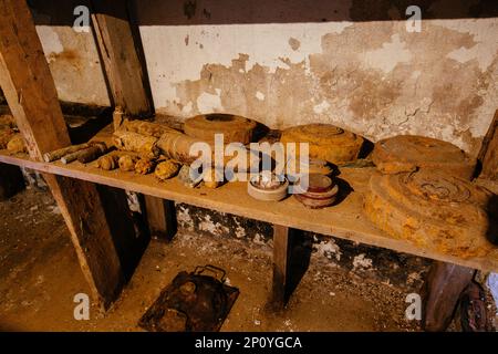 Old rusty ammo, tank shells, mines and grenades, dug out after demining. Stock Photo