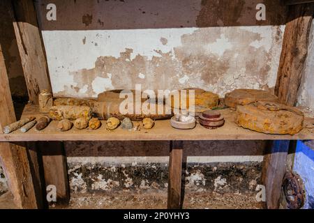 Old rusty ammo, tank shells, mines and grenades, dug out after demining. Stock Photo