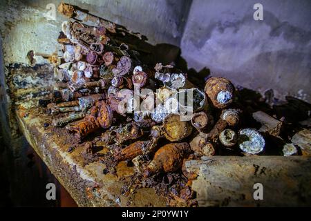 Old rusty ammo, tank shells, mines and grenades, dug out after demining. Stock Photo