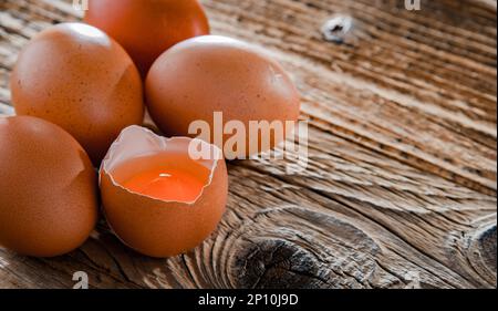 Composition with five chicken eggs on a wooden table. Stock Photo