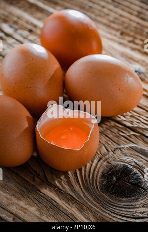 Composition with five chicken eggs on a wooden table. Stock Photo