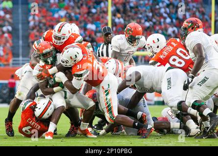 Miami Gardens, Florida, USA. 3rd Sep, 2016. Miami Hurricanes running back Gus  Edwards (7) eludes a tackle attempted by Florida A&M Rattlers linebacker  Adarius Smith (54) at Hard Rock Stadium in Miami