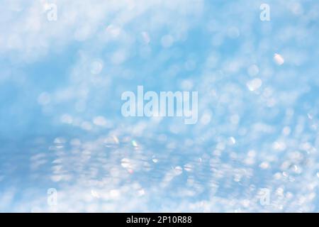 Blue and white snow bubble blurred background. Shining frozen snowy white christmas background Stock Photo