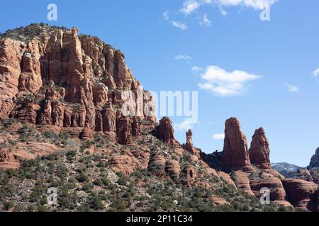 Red rocks of Sedona, Arizona, with puffy white clouds in a blue sky. Stock Photo