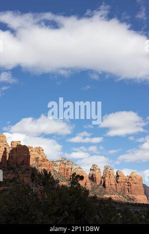 Red rocks of Sedona, Arizona, with puffy white clouds in a blue sky. Stock Photo