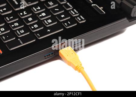 laptop with USB orange cable Stock Photo