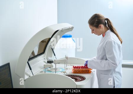 Woman conducts laboratory diagnostics in the testing unit Stock Photo