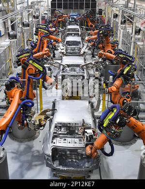 (230303) -- GUANGZHOU, March 3, 2023 (Xinhua) -- Robots conduct welding work at the workshop of GAC Aion, an NEV subsidiary of Guangzhou Automobile Group Co., Ltd. (GAC Group), in Guangzhou, south China's Guangdong Province, Feb. 24, 2023. Guangzhou, one of China's major car manufacturing bases, has been striving to attract investment in NEV industry in recent years. (Xinhua/Deng Hua) Stock Photo