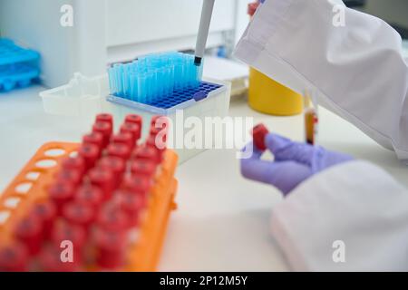 Test tubes with biomaterial in laboratory are collected in blocks Stock Photo
