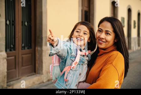 Happy filipina mother bringing her daughter at school - Biracial family concept Stock Photo