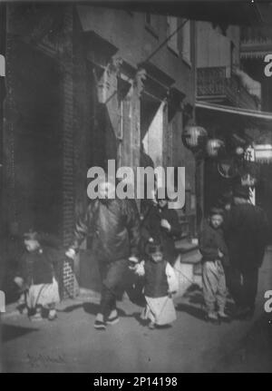 Man and two boys walking along a street, Chinatown, San Francisco, between 1896 and 1906. Stock Photo