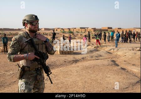 U.S. Air Force Staff Sgt. Benjamin Hinderman, 409th Expeditionary Security Forces Squadron, Quick Reaction Force (QRF) member, maintains security while conducting a joint patrol with the Niger Armed Forces (FAN) near AB 201, Niger, Jan. 6, 2023. QRF postures in and around the base to be able to rapidly respond to developing hostile threats on or immediately around the base. Stock Photo