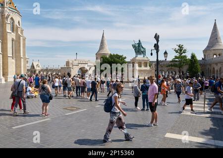 Tourists from all over the world at the Trinity Square in Budapest with the Fishermen's Bastion in the background Stock Photo