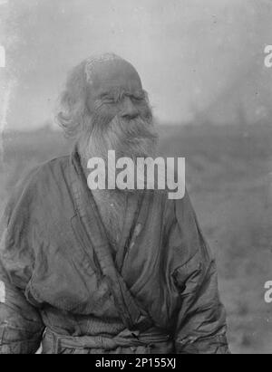 Ainu man standing outside, 1908. Stock Photo