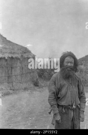 Ainu man standing outside, 1908. Stock Photo