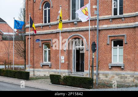 Merchtem, Flemish Brabant Region, Belgium, Feb. 25 2023 - Facade with flags of the village and municipâlity hall Stock Photo