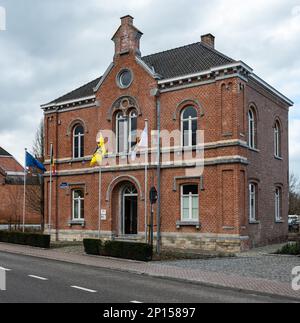 Merchtem, Flemish Brabant Region, Belgium, Feb. 25 2023 - Facade with flags of the village and municipâlity hall Stock Photo