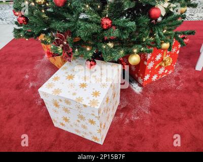 Christmas tree and gift boxes next to it Stock Photo