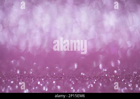 Shiny background, shimmering texture full of reflections and tinsel in color pink. Stock Photo