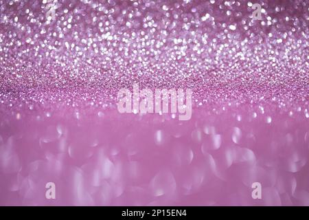 Shiny background, shimmering texture full of reflections and tinsel in color pink. Stock Photo