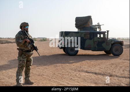 U.S. Air Force Staff Sgt. David Vega, 409th Expeditionary Security Forces Squadron, Quick Reaction Force (QRF) member, maintains security while conducting a joint patrol with the Niger Armed Forces (FAN) near AB 201, Niger, Jan. 6, 2023. QRF postures in and around the base to be able to rapidly respond to developing hostile threats on or immediately around the base. Stock Photo