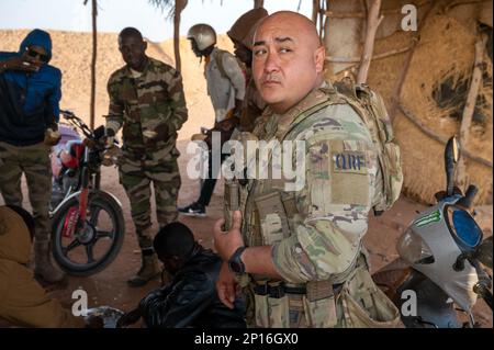 Senior Airman Jose Leos, 409th Expeditionary Security Forces Squadron, Quick Reaction Force (QRF) member, meets with Niger Armed Forces (FAN) members before conducting a joint patrol at AB 201, Niger, Jan. 6, 2023. QRF postures in and around the base to be able to rapidly respond to developing hostile threats on or immediately around the base. Stock Photo