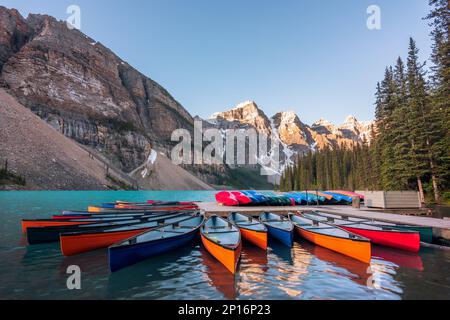 Moraine Lake in Banff National Park with the boat dock in front of water during sunrise Stock Photo