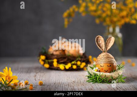 Easter bunny egg. Egg decorated with twine like a cute rabbit. Handmade toy. Stock Photo