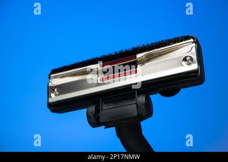 Dirty vacuum cleaner brush isolated on blue background studio shot. Stock Photo