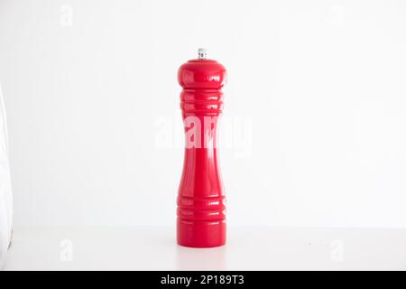 Wooden red salt grinder mill studio shot isolated on white. Stock Photo