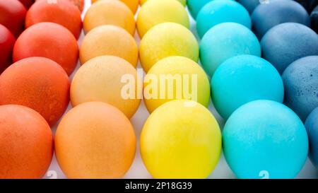 Easter eggs banner in minimal style close up photo with copy space. Rainbow colored easter eggs background. The eggs are painted in the rainbow colors Stock Photo