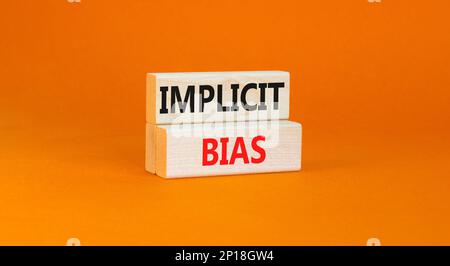 Implicit bias symbol. Concept words Implicit bias on wooden block. Beautiful orange table orange background. Business psychology implicit bias concept Stock Photo