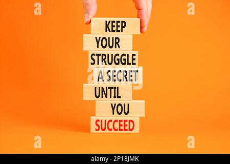 Keep secret symbol. Concept words Keep your struggle a secret until you succeed on wooden blocks. Beautiful orange background. Copy space. Businessman Stock Photo