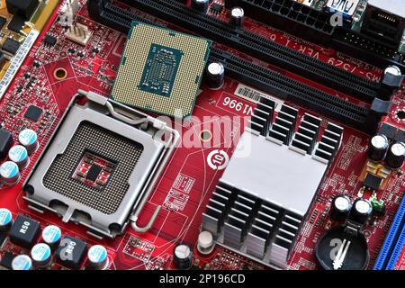 CPU socket and processor on the motherboard. Before installation processor. Motherboard digital chip. Technology background Stock Photo