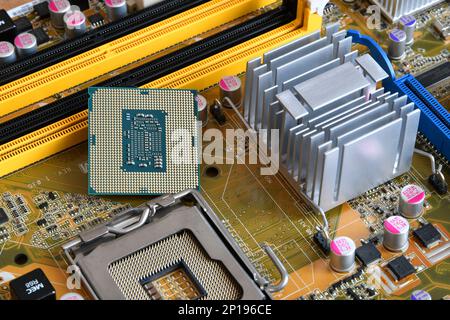 CPU socket and processor on the motherboard. Before installation processor. Motherboard digital chip. Technology background Stock Photo