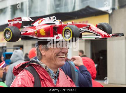 Kim Reimer from Tallahassee Fla. wears a Ferrari car hat at Circuit Gilles Villeneuve during the open house day at the F1 Canadian Grand Prix auto race Thursday June 9 2016 in