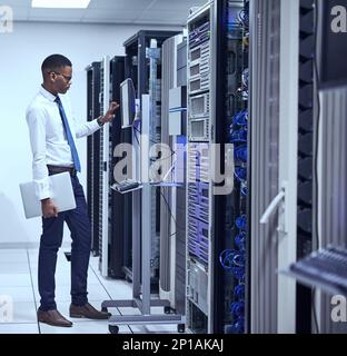 Running diagnostics. Cropped shot of a IT technician working and checking if all the servers are up and running. Stock Photo