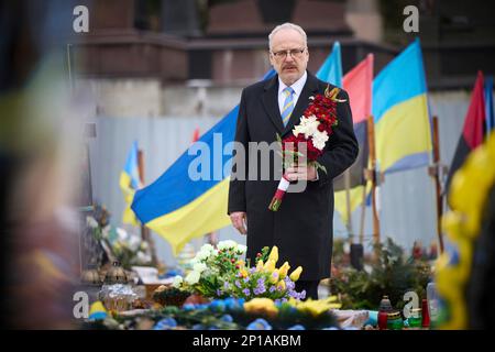 Lviv, Ukraine. 03rd Mar, 2023. Latvian President Egils Levitson pauses before placing flowers on the graves of Ukrainian defenders at the Field of Honor Lychakiv Cemetery, March 3, 2023 in Lviv, Ukraine. Credit: Pool Photo/Ukrainian Presidential Press Office/Alamy Live News Stock Photo