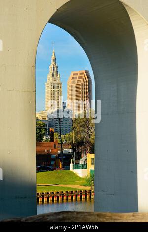 Two of Cleveland Ohio’s most prominent downtown skyscrapers are framed in the arch of a high bridge Stock Photo