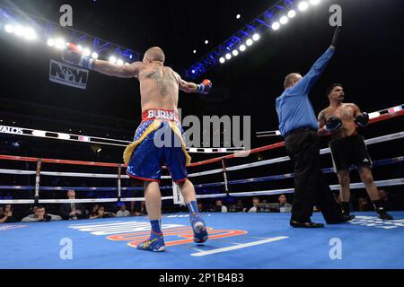 May 28, 2016; Clay Burns (blue trunks) and Isaac Avalos (black trunks) box  during their lightweight boxing match at Gila River Arena in Glendale, AZ.  Burns won via second round TKO. Joe