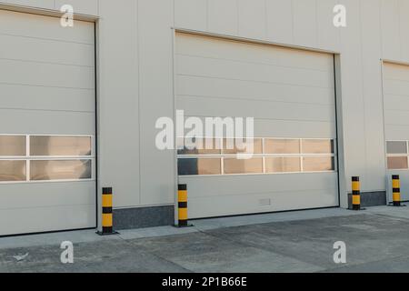 A closeup shot of automatic metal roller door used in factory, storage, garage, and industrial warehouse. The corrugated and foldable metal sheet offe Stock Photo