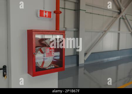 Fire Hose cabinet in the building and light signal. Stock Photo